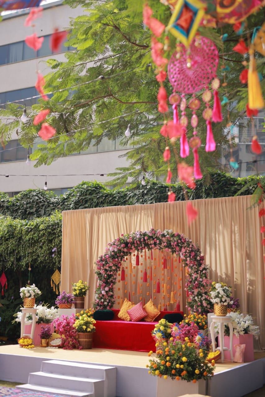 Colorful Outdoor Ceremony with Floral Arch