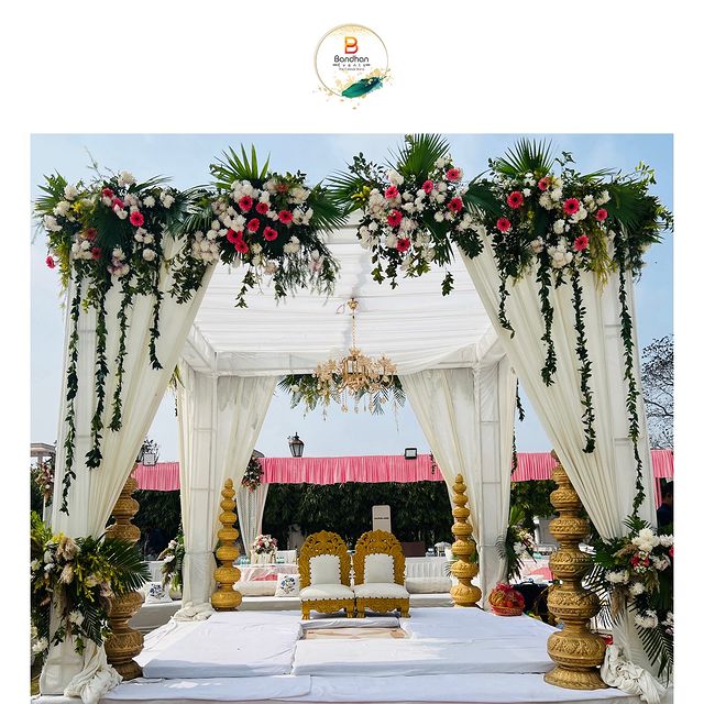 Traditional White Mandap with Golden Pillars and Chandelier