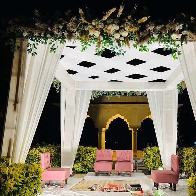 Evening Setup with White Curtained Pavilion and Pink Seating
